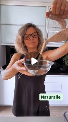 a woman is mixing something in a bowl