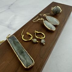 This beautiful gift set is perfect for that special someone. Featuring beautiful natural labradorite stones in each of the pieces creating a breathtaking set. The Labradorite stone is believed to be a stone of transformation and thought to be a useful companion through change, imparting strength and perseverance. The stones are believed to balance and protect the aura, raise consciousness and ground spiritual energies. This set includes 2 pairs of earrings, 1 necklace and 1 ring. The drop earrings are made from golden stainless steel hooks and the small hoops are a plated stainless steel.  NECKLACE LENGTH: 24" (60.96cm) RING SIZE: Adjustable (Approx US Size 6-11) DROP EARRING LENGTH: About 1.2" (31mm) MATERIAL: Natural Labradorite Gemstone, Stainless Steel Earring Hooks, Gold Plated Alloy Elegant Labradorite Earrings For Everyday Wear, Labradorite Jewelry With Raw Stone As Gift, Elegant Everyday Labradorite Earrings, Nature-inspired Jewelry With Raw Stone For Gift, Nature-inspired Labradorite Jewelry With Natural Stones, Teardrop Labradorite Jewelry Gift, Labradorite Wire Wrapped Earrings As A Gift, Labradorite Teardrop Earrings For Gift, Labradorite Teardrop Earrings As Gift