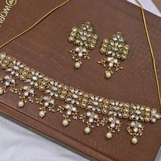 About: Enhance your style with our Designer Gold Plated Royal Kundan Necklace. This elegant set comes with matching earrings to complete your look. The intricate design and gold plating add a touch of royalty to any outfit. Perfect for weddings, parties, or any special occasion. Details: Eye-catching and unique jewelry that will set you apart. Gift this piece to a loved one, and see their face light up with joy. Best for gifting or for personal use, wear it to any occasion and become the spotlig Festive Jewelry Sets With Matching Earrings For Diwali, Gold Kundan Bridal Necklace For Celebrations, Formal Temple Jewelry Kundan Necklace With Matching Earrings, Bollywood Festive Necklaces With Matching Earrings, Festive Gold Kundan Sets, Elegant Festive Kundan Metal Necklace, Gold Jewelry Sets For Diwali Festival, Gold Meenakari Chandbali Jewelry Sets, Bollywood Gold Plated Bridal Necklace