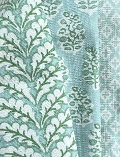 several different patterns are shown together on the fabric, including blue and green colors with white designs