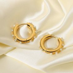 Picking a jewelry piece has never been so easy with these Claudia Earrings. Its round design paired with fresh seawater pearls is the perfect everyday set. Details: 18k Gold Plated Stainless Steel, Freshwater Pearls Diameter: 25.94 mm Elegant Pearl Jewelry In Circle Shape, Elegant Pearl Circle Jewelry, Elegant Circle Pearl Jewelry, Elegant Circular Pearl Jewelry, Tarnish Resistant Round Pearl Earrings For Wedding, Gold Pearl Hoop Earrings For Anniversary, Round Tarnish Resistant Pearl Earrings For Wedding, Round Tarnish-resistant Pearl Earrings For Weddings, Gold Hypoallergenic Pearl Hoop Earrings