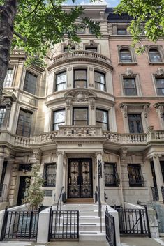 the front entrance to an apartment building with wrought iron railings and gated entry