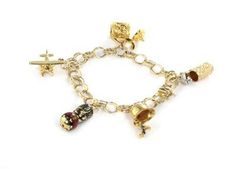 "This is an eye catching vintage charm bracelet, it is crafted from 14k yellow gold with white gold accent. It has a triple ring link bracelet with 5 dangling charms featuring 4 ale tankards in textured finish, one two tone gold, the other in yellow gold, both covers open and close. An airplane, enamel bobble head and a fire hat which opens to reveal an enamel figure. It secures with a push in clasp and is signed 14k. Material:  14k yellow gold   Measurements:  7\" long x 0.32\" wide Charms varies in size from: 0.83\" long -0.55\" long Weight:  26.5 grams Stock#  59667" Fire Hat, Triple Ring, Vintage Charm Bracelet, Gold Accent, Bobble Head, A Fire, Vintage Charms, Gold Accents, Link Bracelets