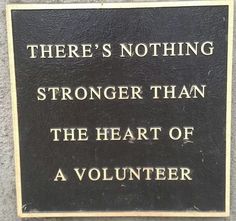 a plaque on the side of a building that says there's nothing stronger than the heart of a volunteer