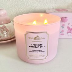 a pink candle sitting on top of a table