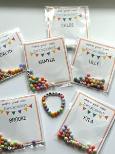 four bags of personalized bracelets with name tags