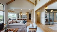 a living room filled with furniture and lots of windows next to a wooden flooring area