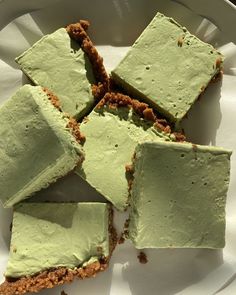 several pieces of green cake on a white plate