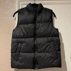 Brand New Black Winter Vest With Pockets, Trendy Black Puffer Vest, Urban Black Vest For Fall, Black Puffer Vest For Winter, Black Puffer Vest For Spring, Black Winter Vest For Cold Weather, Black Vest For Cold Weather And Winter, Trendy Black Vest With Pockets, Casual Black Winter Vest