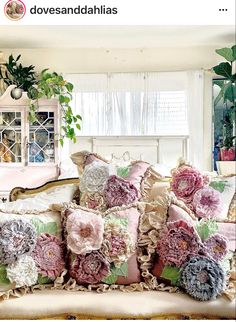 a bunch of pillows sitting on top of a couch