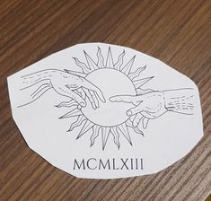 a close up of a sticker on a wooden surface with the word momixi