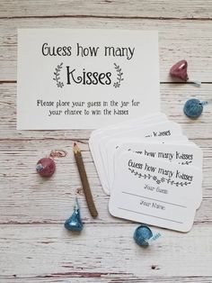 four cards with the words guess how many kissess on them and some other items