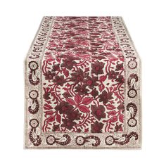 a red and white table runner with floral designs on it, in the shape of a flower