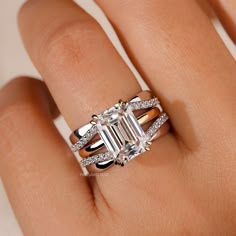 a woman's hand with an engagement ring and diamond set on top of it