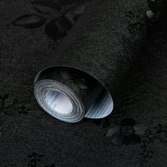 a roll of black fabric with flowers on it