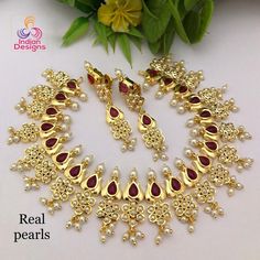 This is an exclusive high quality gold plated designer Indian wedding necklace studded with ruby and emerald stones with real tiny fresh water pearls and in a lotus flower motif. This precision-crafted necklace comes with matching pair of earrings and a complimentary gift box. The necklace is made 22k Gold plated copper, with High quality Cubic Zirconia and real Freshwater Pearls. This is a perfect gift for your beloved one and can be worn at any occasion to make you look more beautiful. This ne Anniversary Temple Jewelry With Pearl Drop, Elegant Red Kundan Gold-plated Necklace, Gold Oval Jewelry Set For Wedding, Elegant Kundan Bridal Necklace For Marriage, Oval Gold Jewelry Set For Wedding, Elegant Kundan Necklaces For Marriage, Oval Temple Jewelry For Anniversary, Oval Pearl Jewelry For Wedding, Ruby Jeweled Necklaces For Wedding