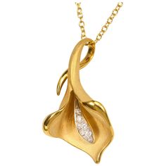 From Annamaria Cammilli's Calla collection, Calla flower shaped pendant necklace handcrafted in 18 karat Sunrise Yellow gold. Hand crafted of polished and satin textured gold, with diamonds. Diamond total weight is 0.09 carat. Pendant dimensions are 30 millimetres tall, 16 millimetres wide and 9 millimetres deep. Chain is 18 karat yellow gold with lobster claw, and measures 18" (45 cm) and can also be worn at 16" (40 cm). Sculpted in Florence, Italy, the Annamaria Cammilli brand is well known fo Formal Yellow Gold Flower Pendant Necklace, Formal Necklace With Polished Flower Pendant, Elegant Necklaces With Flower Pendant And Polished Finish, Elegant Yellow Gold Diamond Necklace With Large Pendant, Formal Flower Pendant Necklace With Polished Finish, Yellow Gold Flower Pendant Necklace With Polished Finish, Yellow Gold Necklace With Flower Pendant And Polished Finish, Elegant Gold Diamond Necklace With Large Pendant, Gold Necklace With Polished Flower Pendant