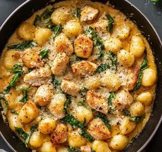 a skillet filled with potatoes and spinach