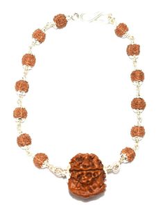 "Product Name : Ganesha Rudraksha Bracelet In silver Bead size : Ganesha Rudraksha (19 mm - 20 mm) , five face rudraksha (6 mm) Design : 1 bead of high quality Ganesha rudraksha of nepal in pure silver attached with small 5 mukhi rudraksha beads ,in silver caps and silver wire having traditional knots design . Origin : Nepal Description : Ganesh Rudraksha bears a Trunk like elevation as is seen on the face of Lord Ganesha, the son of Lord Shiva. Ganesha, the elephant-headed God of success and ov 5 Mukhi Rudraksha, Rudraksha Bracelet, Rudraksha Beads, Bracelet In Silver, Silver Caps, Lord Ganesha, Silver Bead, Lord Shiva, Ganesha