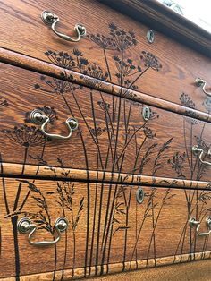 the drawers are decorated with flowers and metal handles