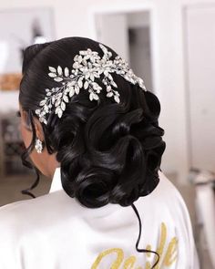 the back of a woman's head wearing a wedding hair comb