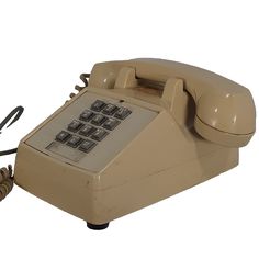 an old style telephone is on display against a white background with the cord still attached