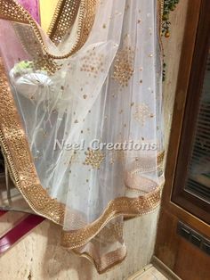 More dupatta here in our collection https://www.etsy.com/shop/neelcreations/?section_id=15880219 * This Bridal Dupatta is sequin embroidered on net with beautiful golden border. This can be your wedding dress chunni for Indian occasion wear for festival. This has perfect bling for you to look classy and ethnic at same time. We can make in other colors. Pair it up with skirt and blouse from our shop. NOTE : There might be slight color variation due to different colour settings. Wedding Resham Embroidered Chanderi Dupatta, Wedding Chanderi Dupatta With Resham Embroidery, Anarkali Set With Sheer Dupatta For Eid, White Dori Work Dupatta For Celebration, Bollywood Style Tissue Silk Dupatta For Wedding, Wedding Chanderi Embroidered Fabric With Sheer Dupatta, White Dupatta With Dori Work For Celebration, Gold Dupatta With Dabka Work For Celebration, Celebration Sheer Dupatta Tissue Silk Sharara