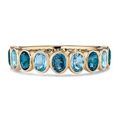 Two shades of natural blue topaz alternate along this stunning bezel-set ring. Crafted in warm 14-karat yellow gold  it features delicate milgrain detail around each hand-selected gemstone for a touch of vintage-inspired flair. Fine Jewelry Yellow Gold Topaz Ring With Bezel Setting, Yellow Gold Topaz Ring With Bezel Setting, Classic Yellow Gold Topaz Ring With Multi-stone, Bezel Set Topaz Ring In Fine Jewelry Style, Heirloom 14k Gold Topaz Ring With Bezel Setting, Fine Jewelry Topaz Ring With Bezel Setting, Elegant Oval Topaz Stackable Ring, Elegant Stackable Blue Topaz Ring, Elegant Blue Topaz Ring With Bezel Setting