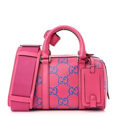 This is an authentic GUCCI Calfskin GG Tennis Bi-Color Embossed Mini Duffle Bag in Modern Fucsia and Modern Blue. This chic mini duffle bag is crafted of pink perforated calfskin leather with blue jumbo GG monogram. The bag features pink rolled top handles, an optional pink canvas shoulder strap, and silver hardware. The top zipper opens to a blue fabric interior with a leather pocket. Mini Duffle Bag, Gg Monogram, Pink Canvas, Leather Pocket, Modern Blue, Gucci Bags, Blue Fabric, Silver Hardware, Gucci Bag