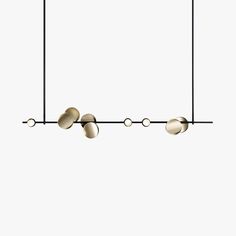 three lights hanging from the ceiling in front of a white background