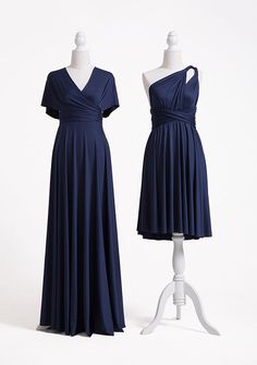 two dresses on mannequins, one in blue and the other in white