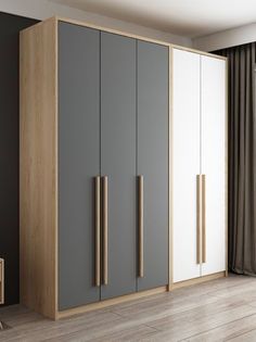 an empty room with grey and white cupboards, wood handles and wooden flooring