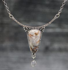 This pendant features a beautiful laguna lace agate that has a soft blend of grays, creams and pops of orange colors. The banding is beautiful on this stone and the tongue shape it has makes for a dramatic pendant. I have paired it up with a beautiful pale pink rose quartz that accents the stone perfectly. Flip the pendant over and I have textured the metal with a pattern that mimics the pattern in the stone. The details on this pendant were all carefully thought out to create a true statement p Unique Necklace Designs, Contemporary Handmade Jewelry, Silversmithing Jewelry, Metal Jewelry Making, Fancy Jewelry Necklace, Metalwork Jewelry, Rose Quartz Pendant, Fancy Jewelry, Silver Jewelry Handmade