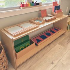 a child's playroom with toys on the floor and in front of a window