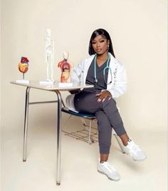 a female doctor sitting at a desk with medical equipment