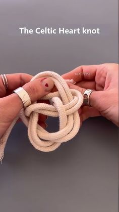 two hands are holding a piece of fabric that is knoted together and the text, the celtic heart knot