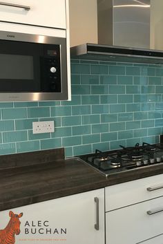 a stove top oven sitting inside of a kitchen next to a microwave above a counter