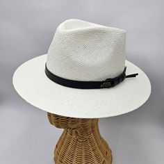 Panama Hat Indiana Style with leather strap, meticulously crafted to evoke timeless sophistication. Each strand woven with precision, it exudes vintage charm and unparalleled elegance, offering a stylish nod to a bygone era. This Panama hat was hand woven by skilled natives in Ecuador and it was carefully completed in Italy. Made from the fibers of the Toquilla Palm plant native to Ecuador. The hat gained international fame during the construction of the Panama Canal in the late 19th and early 2 Luxury Panama Hat For The Beach, Luxury Panama Hat For Beach, Classic Adjustable Panama Hat For Formal Occasions, Luxury Adjustable Fedora For The Beach, Luxury Wide Brim Panama Hat, Luxury Adjustable Fedora For Beach, Elegant Fedora With Curved Brim For Travel, Elegant Short Brim Panama Hat For Travel, Elegant Travel Fedora With Curved Brim