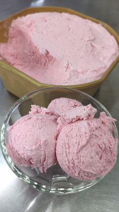 three scoops of pink ice cream in a bowl