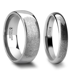 two men's wedding bands with fingerprints on them