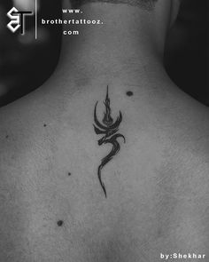 the back of a man's neck with a tattoo design on his upper part