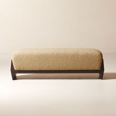 an upholstered bench is shown against a plain background with no one in it