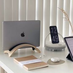 an apple computer sitting on top of a white desk