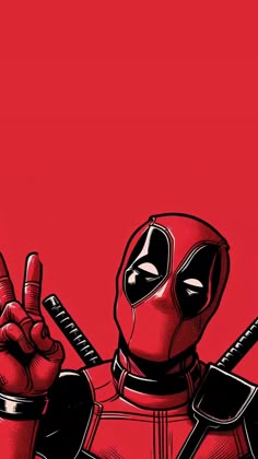 the deadpool is pointing at something with his hand and wearing a red suit, standing in front of a red background