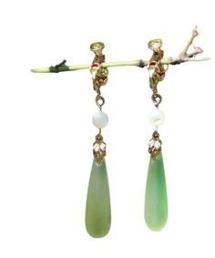 Indulge in luxury with our Chic Green Sterling Silver Alloy Pearl Drop Earrings. The alluring green stones sit delicately on the sterling silver alloy, reflecting sophistication and elegance. The perfect accessory for any occasion, these earrings will elevate your style and leave a lasting impression. Measurement: 5cm/1.95" * 0.9cm/0.351". Matches easily with daily hairstyle. dresses & Shirts Green Jade Earrings For May Birthstone, Fine Jewelry Pear-shaped Earrings For May Birthstone, Fine Jewelry Pear-shaped May Birthstone Earrings, Green Emerald Earrings For Anniversary, Green Gemstone Drop Crystal Earrings, Green Teardrop Clip-on Earrings, Green Earrings For Anniversary, May Birthstone, Green May Birthstone Earrings For Anniversary, Jade Dangle Earrings For Pierced Ears