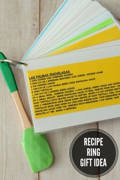 recipe ring gift idea with green spatula and cookbook on wooden table next to it