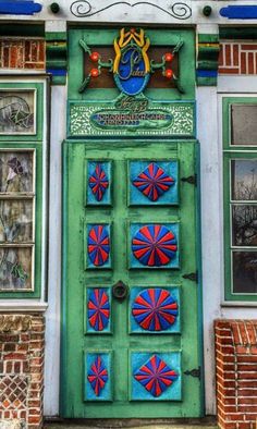 a green door with red and blue decorations on it