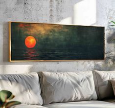 a painting hanging on the wall above a couch