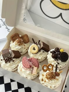 a box filled with cupcakes covered in frosting and toppings