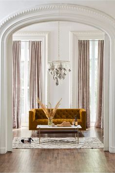 a living room filled with furniture and a chandelier